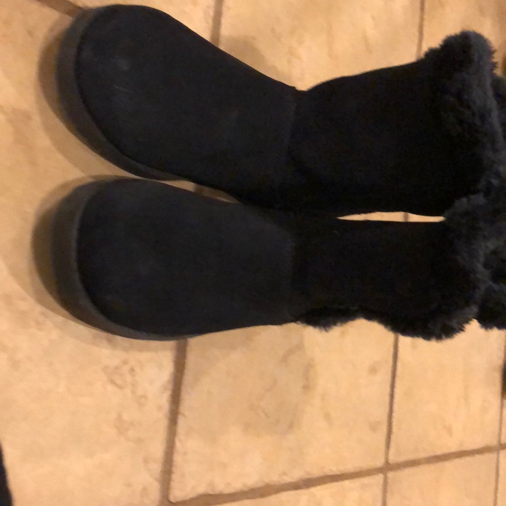 fuzzy dark navy boots with a botton up side.